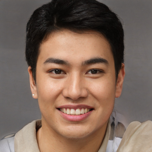 Joyful asian young-adult male with short  brown hair and brown eyes