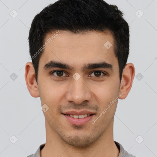 Joyful latino young-adult male with short  brown hair and brown eyes