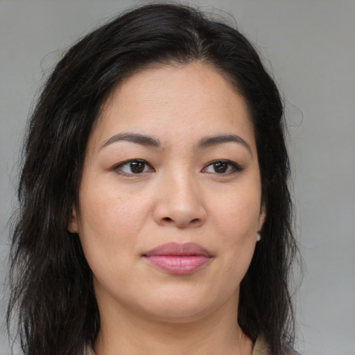 Joyful asian young-adult female with long  brown hair and brown eyes