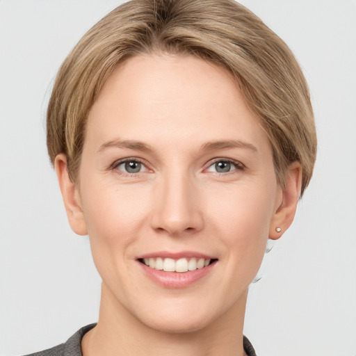 Joyful white young-adult female with short  brown hair and grey eyes