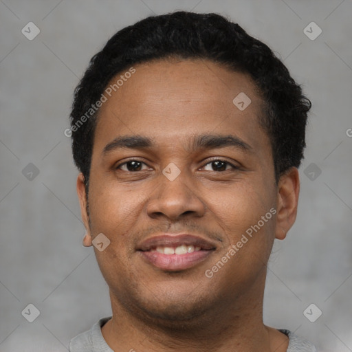 Joyful black young-adult male with short  black hair and brown eyes