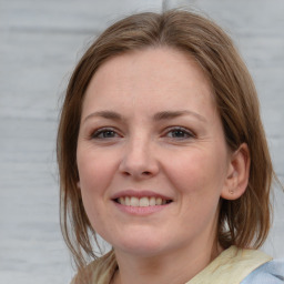 Joyful white young-adult female with medium  brown hair and blue eyes