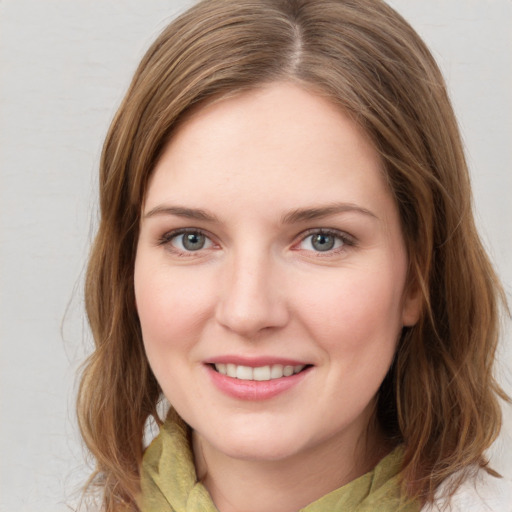 Joyful white young-adult female with medium  brown hair and green eyes