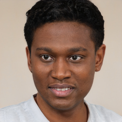 Joyful black young-adult male with short  black hair and brown eyes