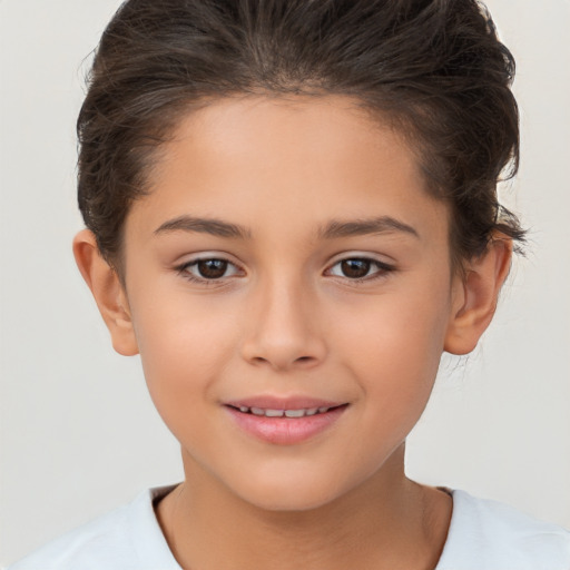 Joyful white child female with short  brown hair and brown eyes