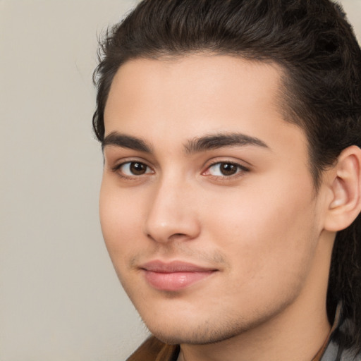 Joyful white young-adult male with long  brown hair and brown eyes