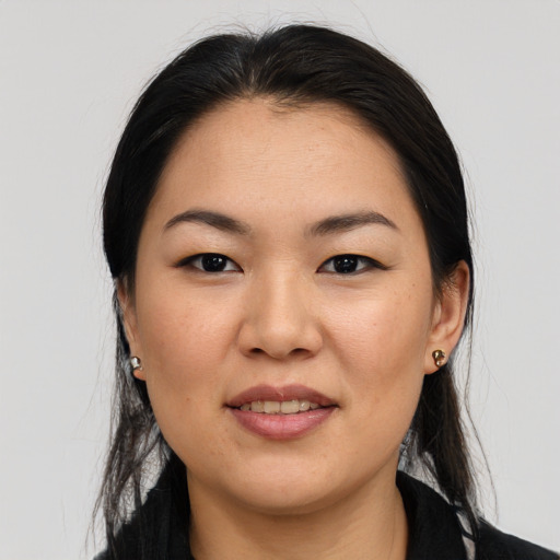 Joyful asian young-adult female with medium  black hair and brown eyes
