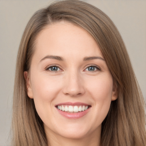 Joyful white young-adult female with long  brown hair and grey eyes