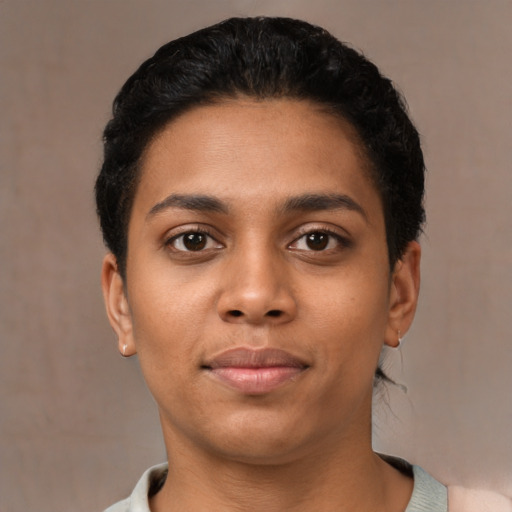 Joyful latino young-adult female with short  black hair and brown eyes