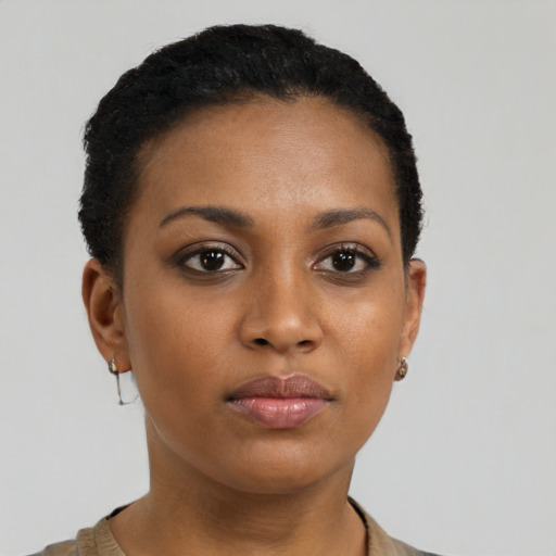 Joyful black young-adult female with short  brown hair and brown eyes