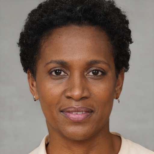 Joyful black young-adult female with short  brown hair and brown eyes
