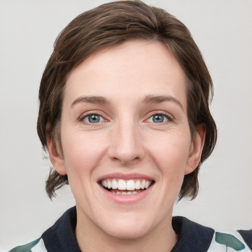 Joyful white young-adult female with medium  brown hair and green eyes