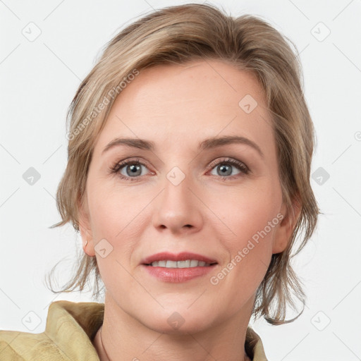 Joyful white adult female with medium  brown hair and blue eyes