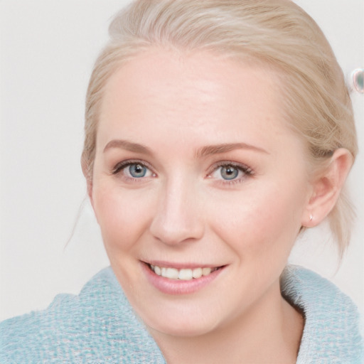 Joyful white young-adult female with medium  brown hair and blue eyes