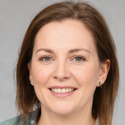 Joyful white adult female with medium  brown hair and grey eyes