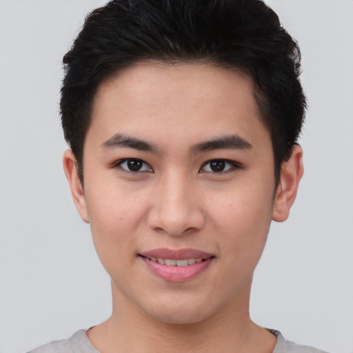 Joyful asian young-adult male with short  brown hair and brown eyes