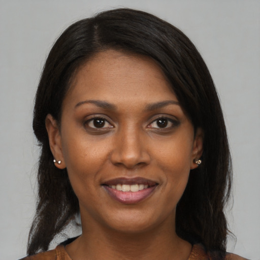 Joyful black young-adult female with medium  brown hair and brown eyes