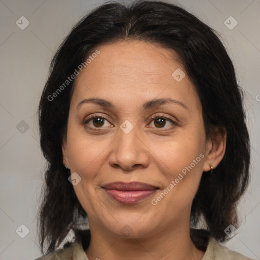 Joyful latino adult female with medium  brown hair and brown eyes