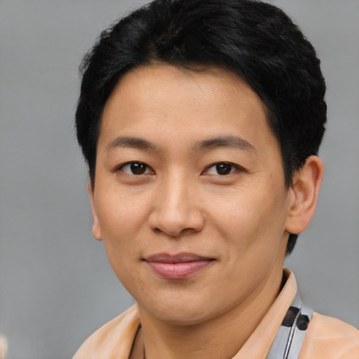 Joyful asian young-adult male with short  brown hair and brown eyes