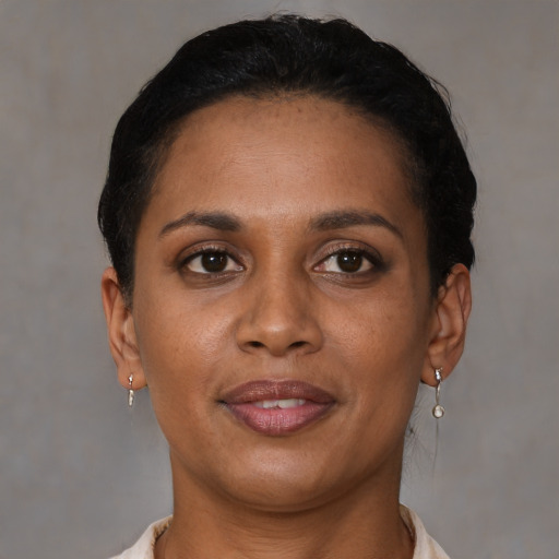Joyful black young-adult female with short  brown hair and brown eyes