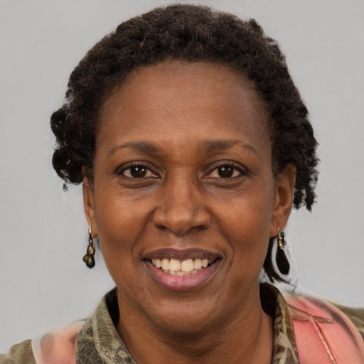 Joyful black adult female with medium  brown hair and brown eyes