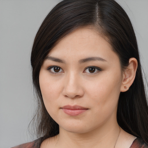 Joyful asian young-adult female with long  brown hair and brown eyes