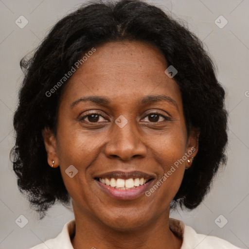 Joyful black adult female with short  brown hair and brown eyes