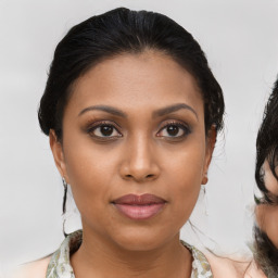 Joyful latino young-adult female with medium  brown hair and brown eyes