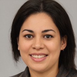 Joyful latino young-adult female with medium  brown hair and brown eyes