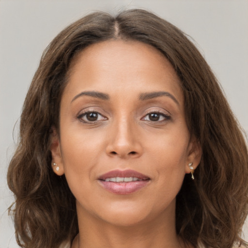 Joyful white young-adult female with long  brown hair and brown eyes