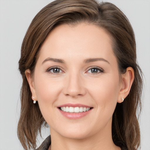 Joyful white young-adult female with long  brown hair and grey eyes