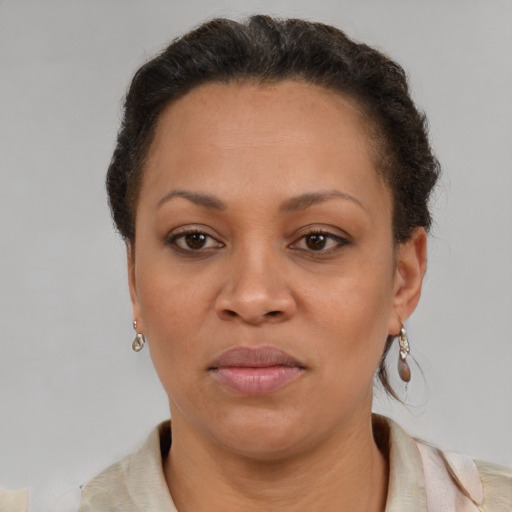 Joyful latino adult female with short  brown hair and brown eyes