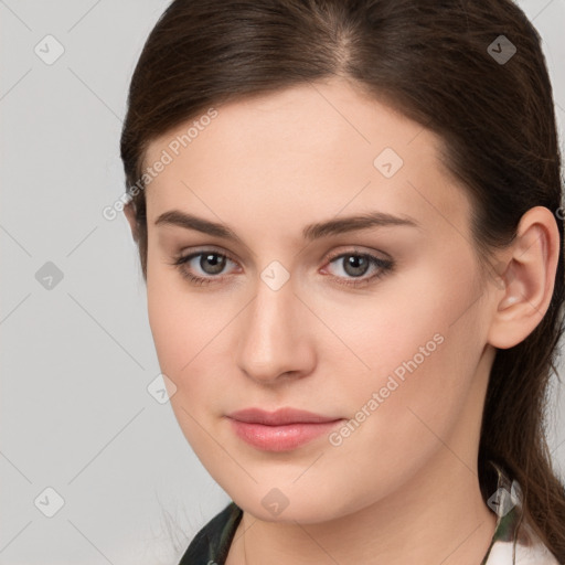 Neutral white young-adult female with long  brown hair and brown eyes