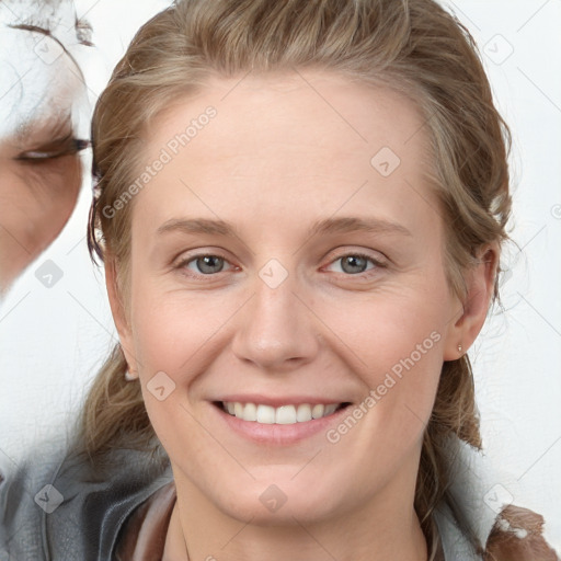 Joyful white young-adult female with medium  brown hair and blue eyes