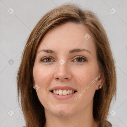 Joyful white young-adult female with medium  brown hair and green eyes