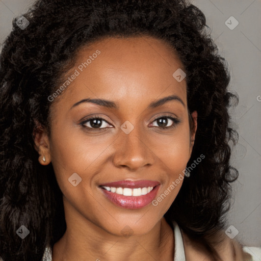 Joyful black young-adult female with long  brown hair and brown eyes