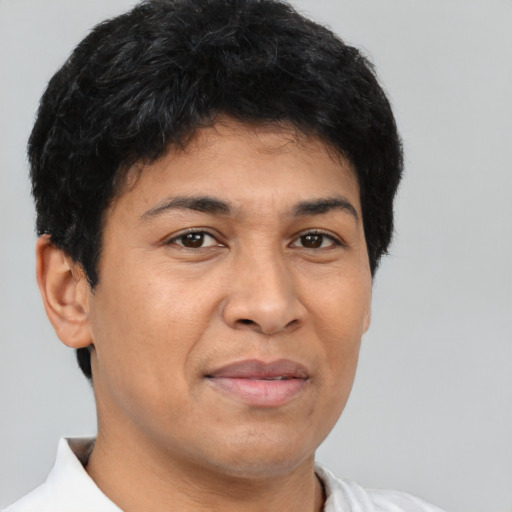 Joyful latino young-adult male with short  black hair and brown eyes