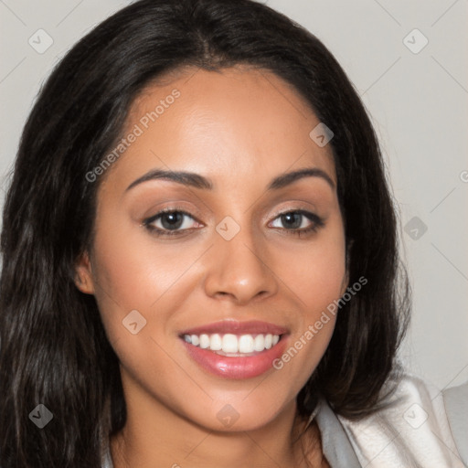 Joyful latino young-adult female with long  brown hair and brown eyes