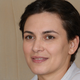 Joyful white adult female with medium  brown hair and brown eyes