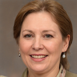 Joyful white adult female with medium  brown hair and grey eyes