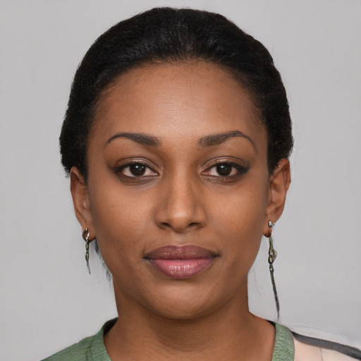 Joyful black young-adult female with short  brown hair and brown eyes