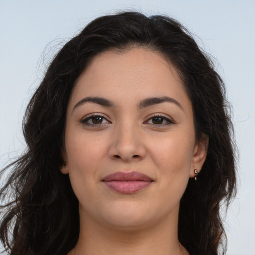 Joyful latino young-adult female with long  brown hair and brown eyes