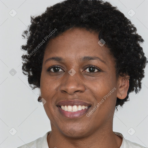 Joyful black adult female with short  brown hair and brown eyes