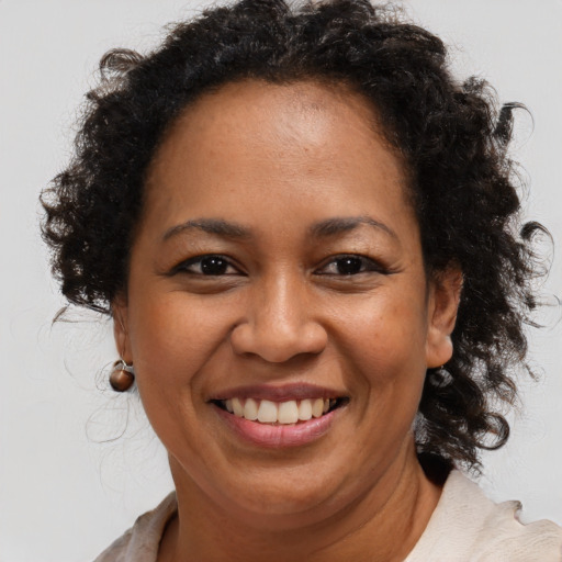 Joyful black adult female with medium  brown hair and brown eyes