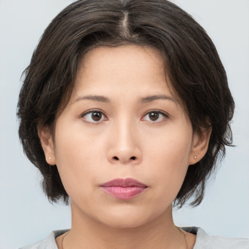 Neutral asian young-adult female with medium  brown hair and brown eyes