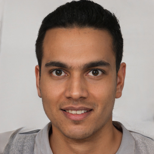 Joyful white young-adult male with short  black hair and brown eyes