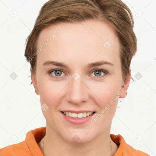 Joyful white young-adult female with short  brown hair and blue eyes