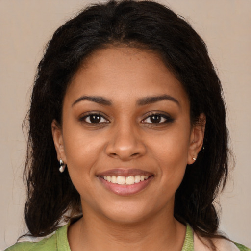 Joyful black young-adult female with medium  brown hair and brown eyes
