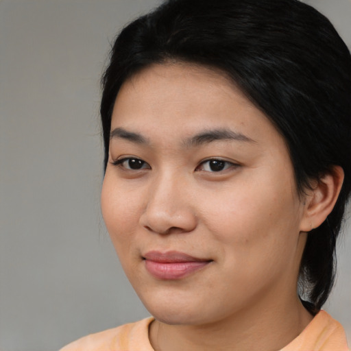 Joyful asian young-adult female with medium  black hair and brown eyes