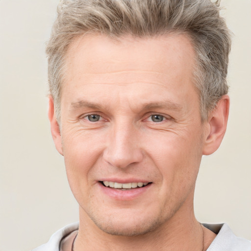 Joyful white adult male with short  brown hair and grey eyes